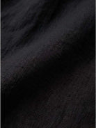 Close-up of soft black pure linen fabric for age-defying button detail shirt
