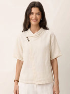 women wearing 100% linen relaxed V-neck top with asymmetrical button detail