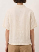 100% linen relaxed V-neck top with asymmetric button detail in navy blue