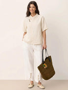 100% linen top with relaxed fit, V-neckline, and asymmetric button detail in navy blue
