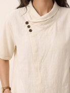 100% linen relaxed V-neck top with asymmetric button detail in navy blue