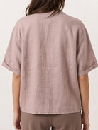 100% linen top with relaxed V-neck, asymmetric button detail, and short sleeves in soft breathable fabric