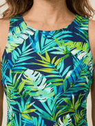 woman wearing high-neck ruched tankini set with printed top and solid swim skirt at the beach