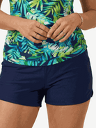 High-neck ruched tankini set with printed top and solid bottom, side ruching, and built-in shelf bra.