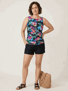 woman wearing a high-neck ruched tankini set with gathered sides and built-in brief suitable for swimming and beachwear