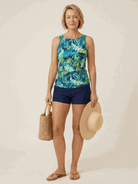 High-neck ruched tankini set with printed top and solid swim skirt bottom, featuring gathered side seams and wide tank straps for beachwear