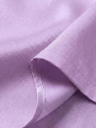 Close-up of silky soft lavender fabric from asymmetrical two-piece trouser set showing fine stitching detail