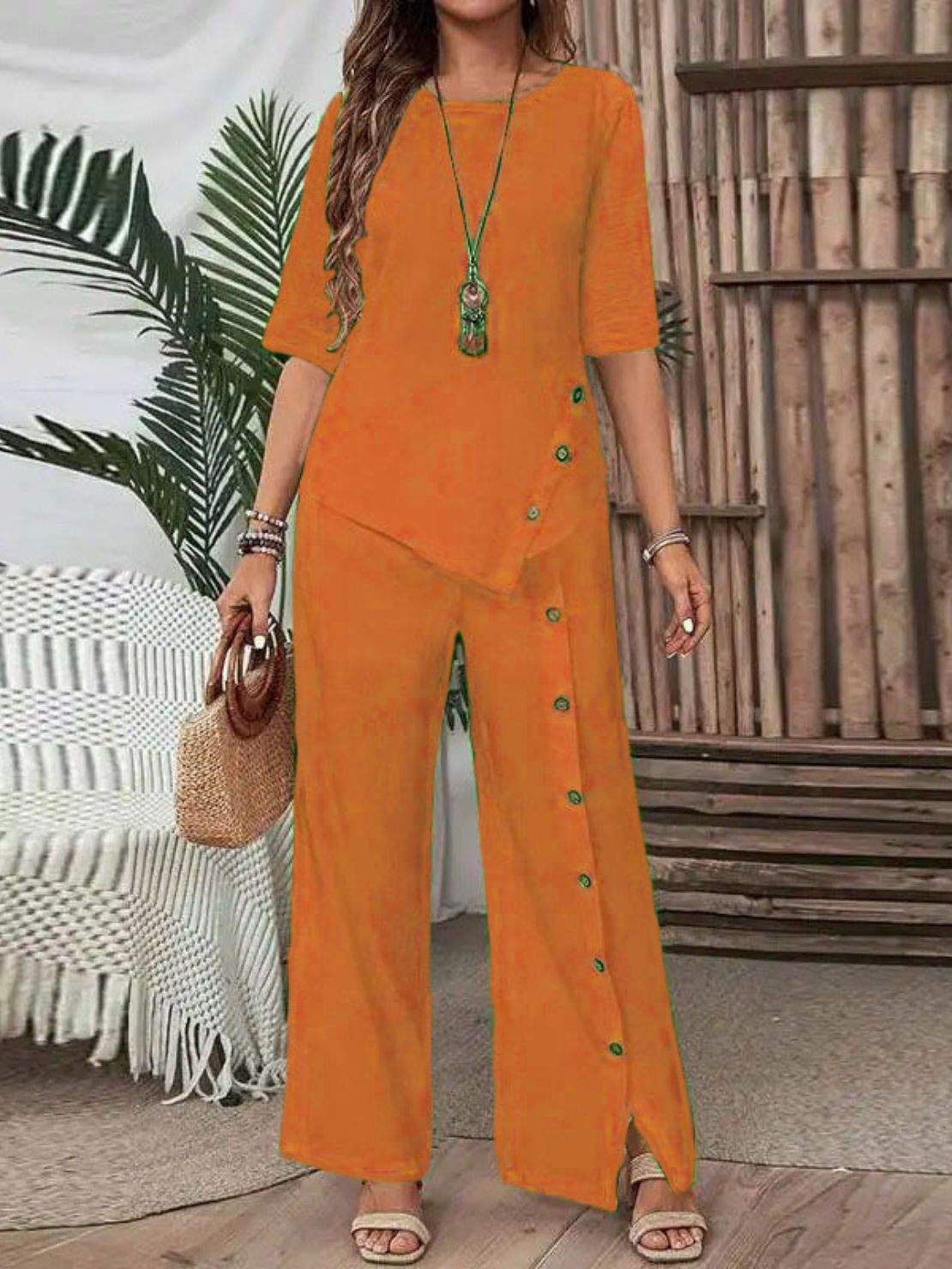 Woman wearing Asymmetry Flow Co-ord with button-front top and flowing pants featuring irregular hem detail.