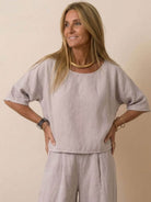 woman wearing beige short-sleeved pullover and wide trouser matching set with relaxed fit