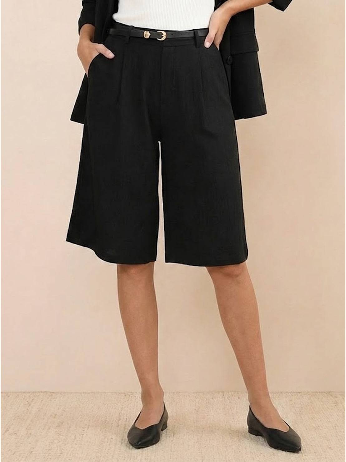 Woman wearing a stylish blazer and high-waisted shorts two-piece set in neutral tones