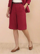 Woman modeling a polished blazer and high-waisted shorts two-piece set in a monochrome color with tailored fit and rolled-up sleeves.