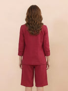 Woman wearing a polished blazer and high-waisted shorts two-piece set in a monochrome outfit