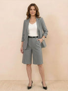 Woman wearing a polished blazer and high-waisted shorts two-piece set in premium fabric for a sleek, slimming look