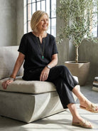 Women wearing breezy cotton blend two-piece set with short-sleeved shirt and elastic waist pants