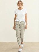 Woman wearing breezy relaxed fit straight pants in casual stylish setting