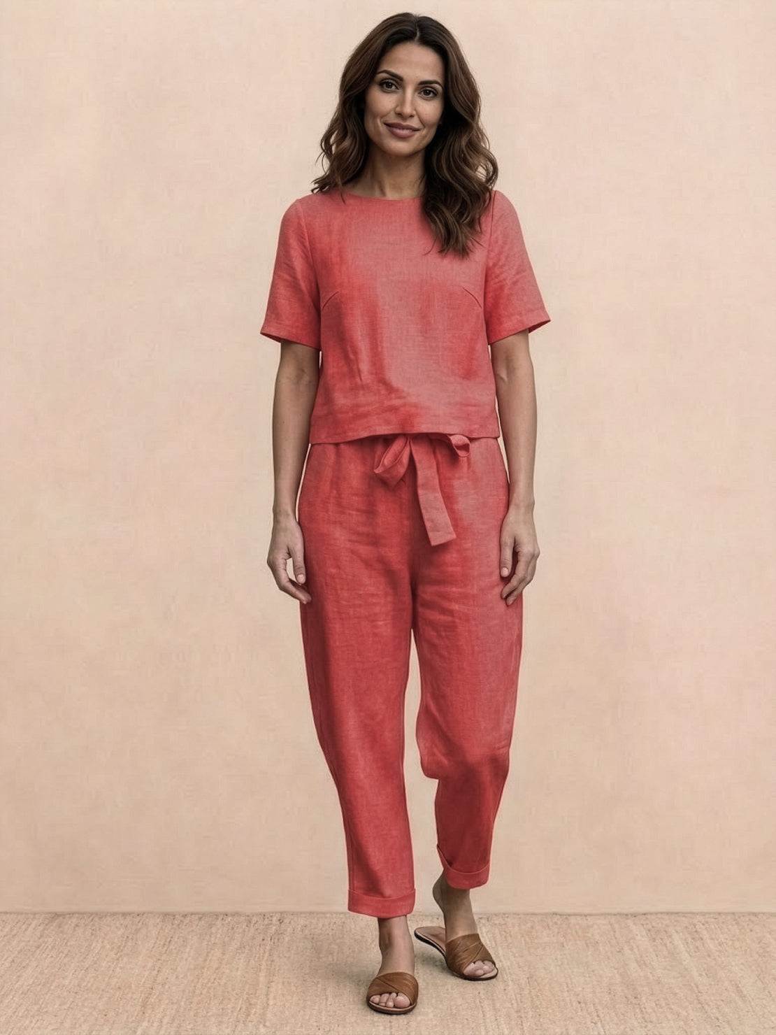 Woman wearing relaxed cotton linen set with short-sleeve top and straight-leg pants in monochrome tones