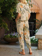 Woman wearing a relaxed cotton linen set with short-sleeve top and straight-leg pants in monochrome tones