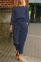 woman wearing navy blue cotton-linen monochrome capsule relaxed longline top and wide-leg pants set walking outdoors