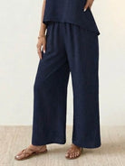 Woman wearing Dreamcatcher Crochet-Back two-piece set with crochet mandala back and wide-leg palazzo pants