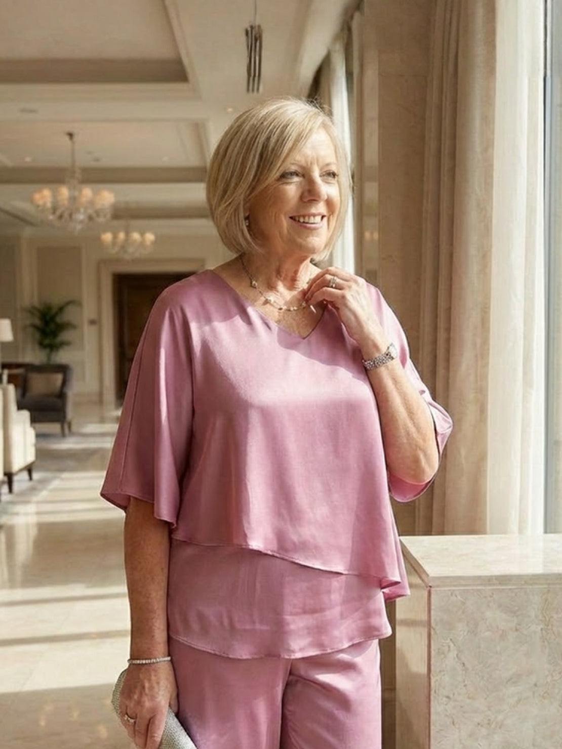 Woman wearing Elegant Layers Two-Piece Set with layered V-neck top and matching pants in soft fabric