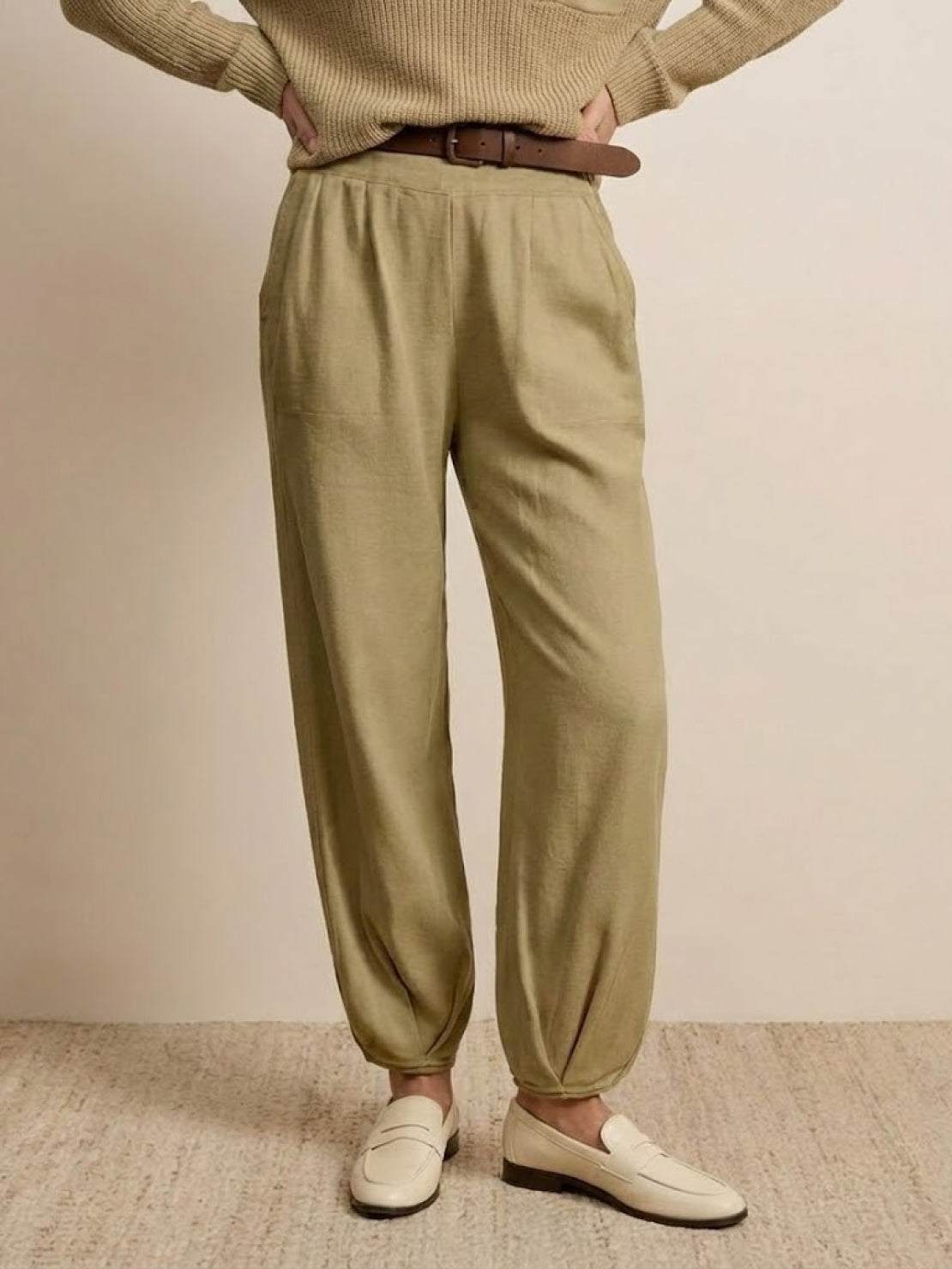 European minimalism relaxed sweater top and khaki trouser set with belt and white loafers