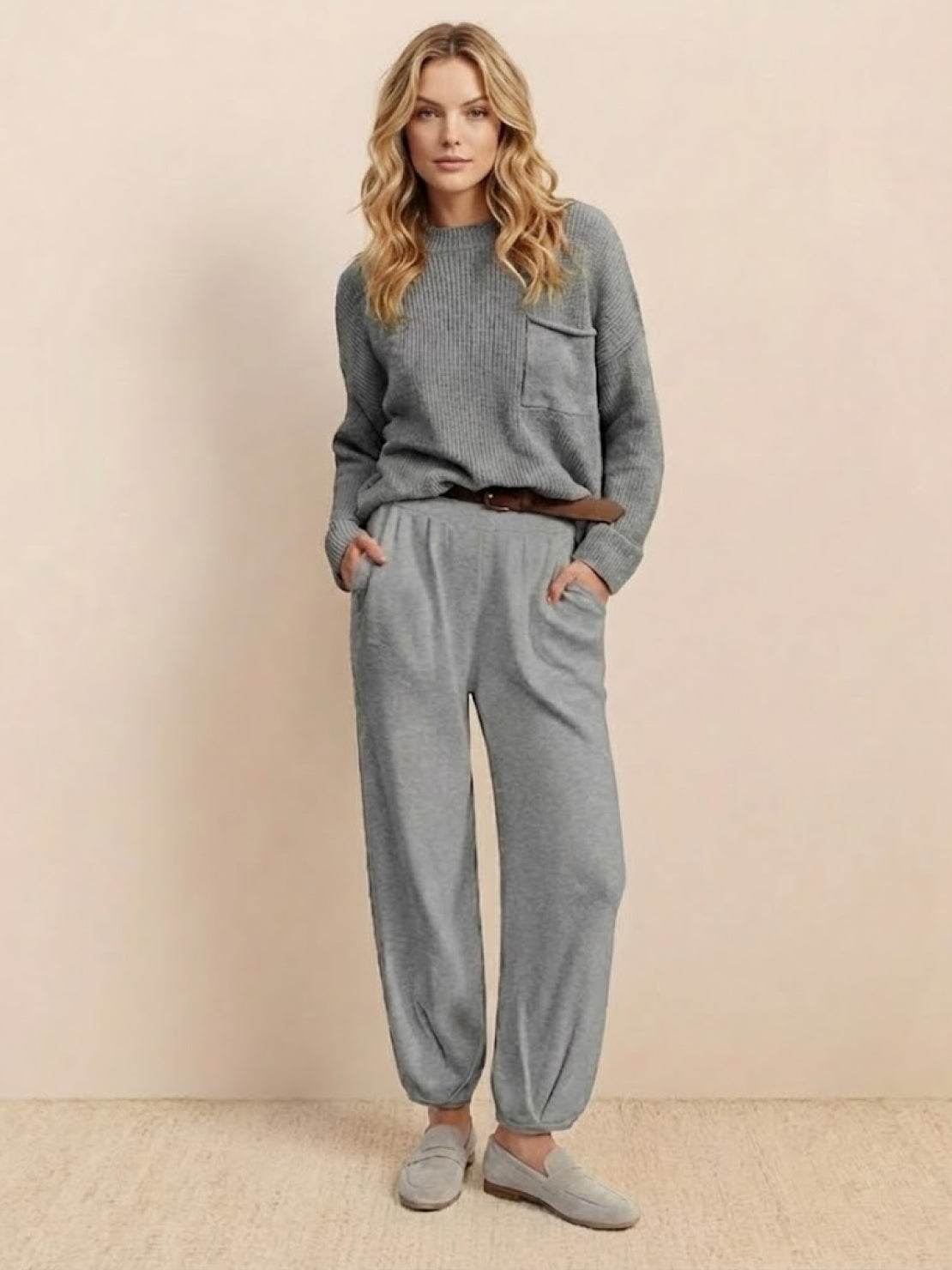 Woman wearing a gray relaxed sweater top and trouser set embodying European Minimalism style