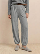 Gray relaxed knit trousers styled for European minimalism fashion