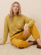 European minimalism relaxed knit sweater and mustard trousers set for casual wear