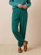 European Minimalism relaxed green trousers with knit texture and brown loafers for casual comfort