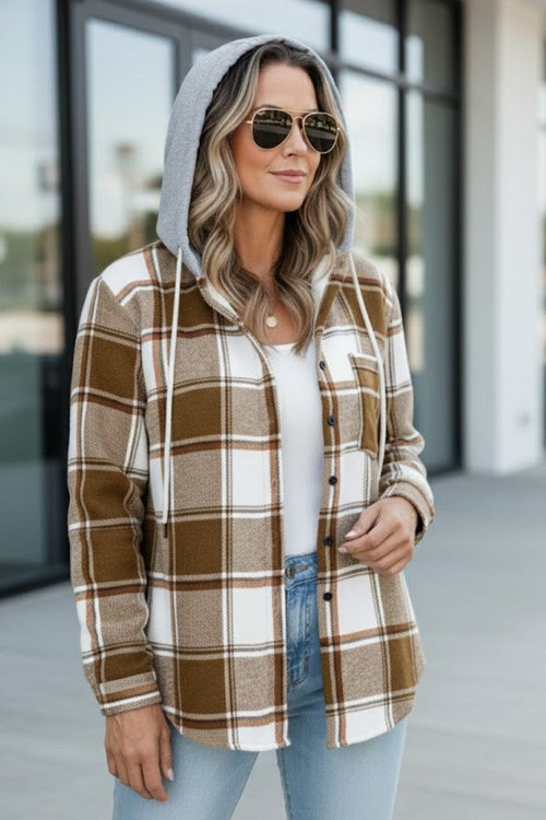 Woman wearing Highland Plaid Shacket with brown and white plaid pattern, soft fleece lining, and attached gray hood.
