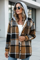 Highland Plaid Shacket with hood, plaid pattern, and button-front closure, styled on a woman outdoors