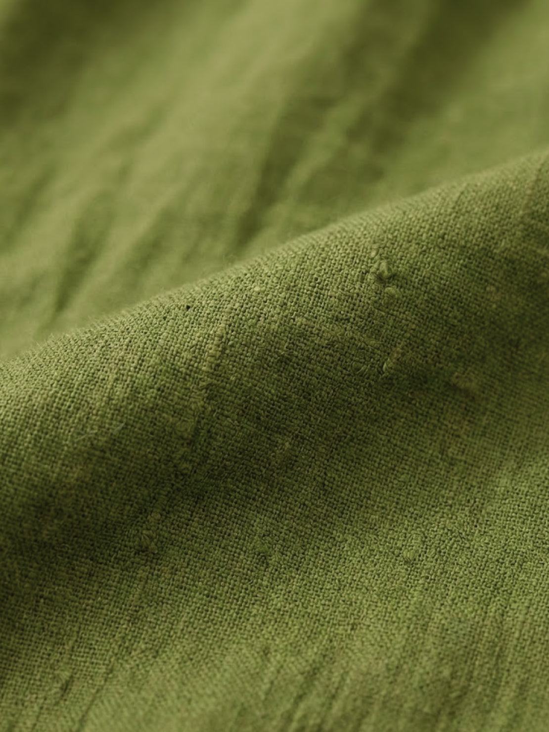 close-up of olive green loose solid color fabric texture