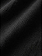 Close-up of black loose solid color fabric with soft, breathable texture