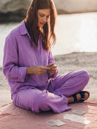 Woman wearing oversized 100% cotton shirt and wide-leg pants co-ord set in neutral tone