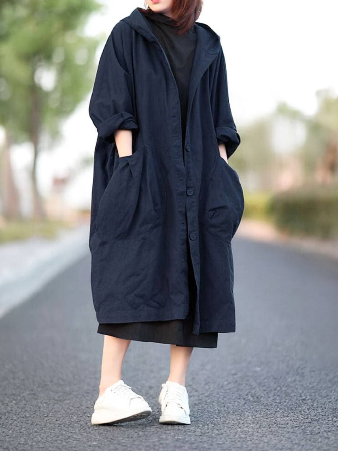 Oversized one-size water-resistant windbreaker jacket with waterproof design and attached hood for protection against rain and wind.