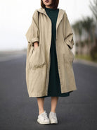 Oversized water-resistant windbreaker jacket with hood and large pockets, lightweight waterproof design for layering and trans-seasonal wear