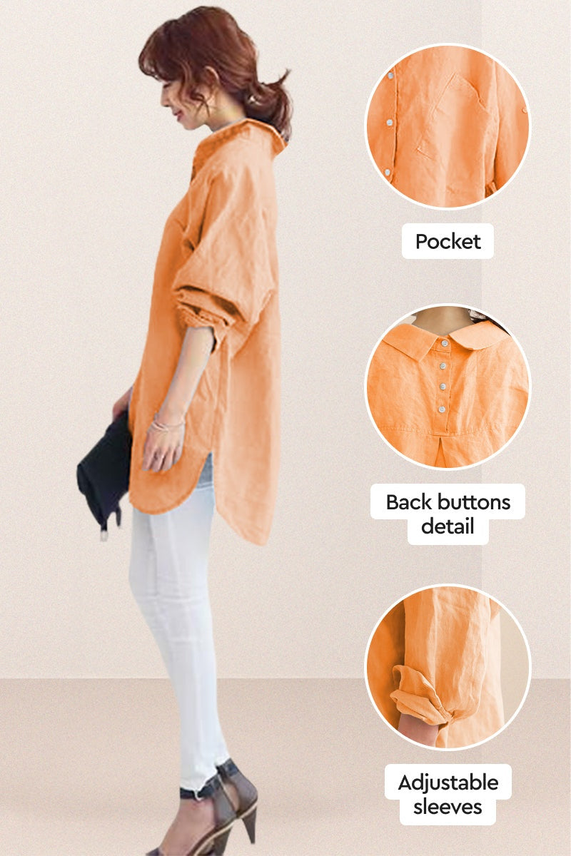 Side view of oversized linen shirt in soft orange with back button details, adjustable sleeves, and pocket, styled with white pants and heels