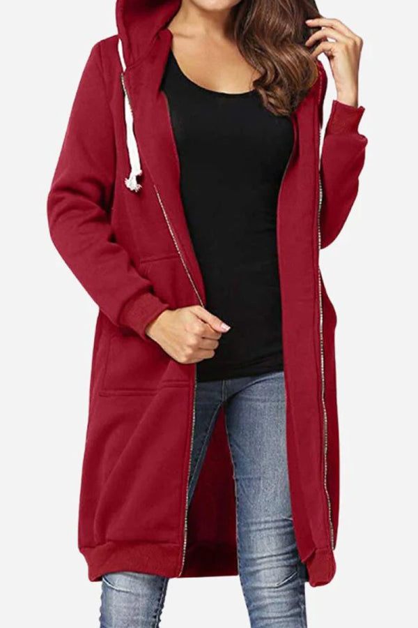 woman wearing oversized long zip sweatshirt hoodie in burgundy with drawstring hood and front pockets
