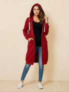 Woman wearing red oversized long zip sweatshirt hoodie with drawstring hood and front pockets