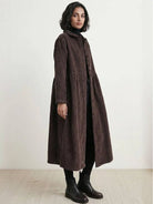 Oversized vintage corduroy coat in warm earth tones with thick texture and classic fit