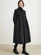 Woman wearing oversized vintage corduroy coat in warm earth tones with cozy texture and roomy fit