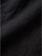 close-up of black pure linen fabric texture for age-defying button detail shirt