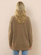 Relaxed fit oversized brown knit cardigan worn by woman, back view