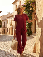 Woman wearing Textured Elegance two-piece set with asymmetrical top and wide-leg pants in soft stretch fabric