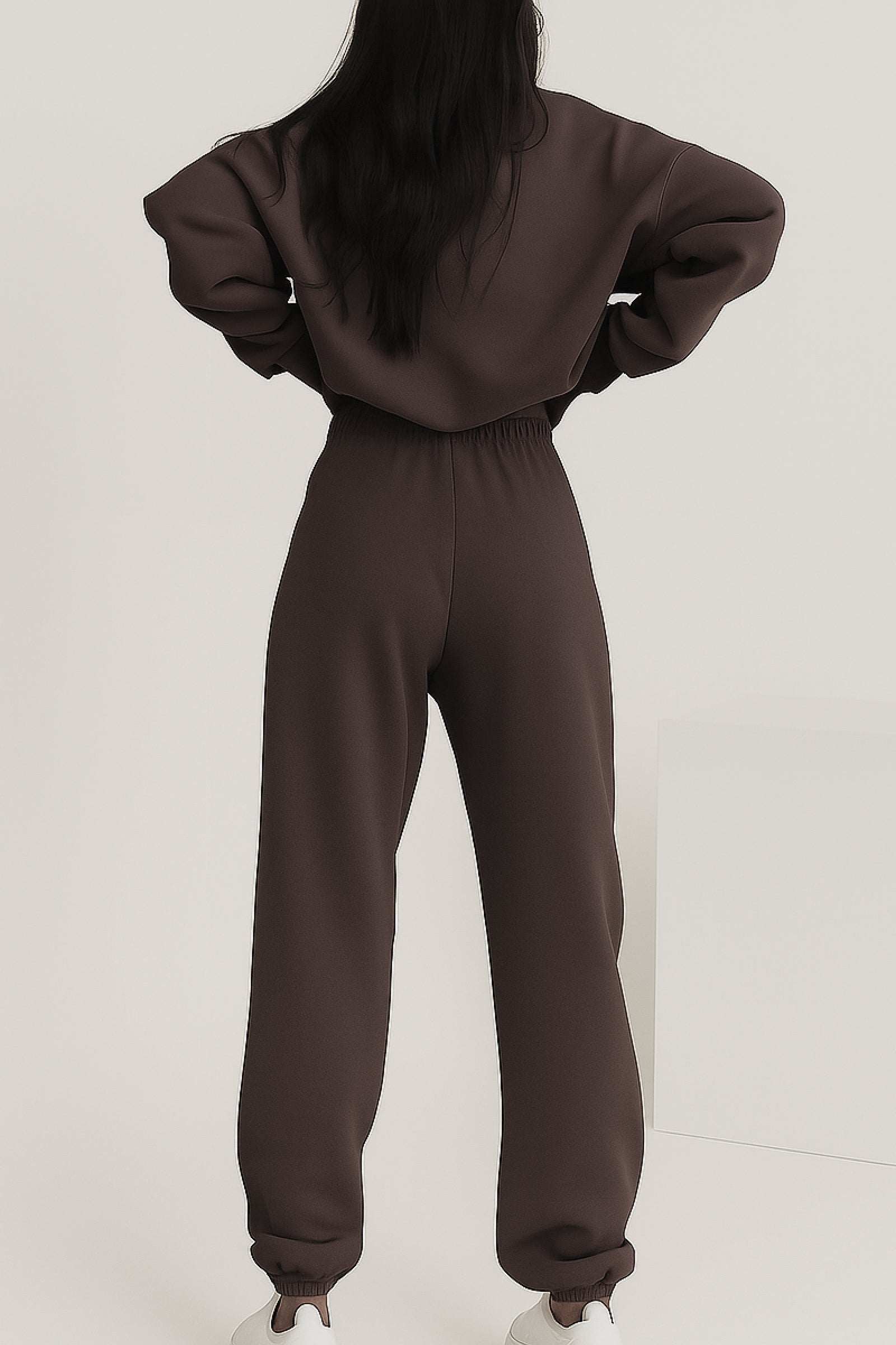 Back view of woman wearing brown cotton blend tracksuit with elastic waistband and cuffs