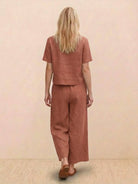 woman wearing a relaxed loose fit co-ord set with soft-tailored top and wide-leg bottoms in solid color