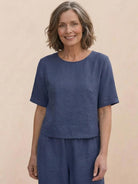 woman wearing a loose fit co-ord set with soft-tailored top and wide-leg bottoms in solid color