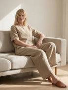 woman wearing loose fit co-ord set with relaxed top and wide-leg trousers in solid color