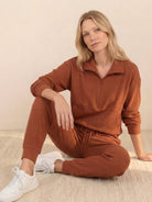 Unisex half-zip pullover and matching sweatpants set in soft fabric for casual comfort and relaxed fit